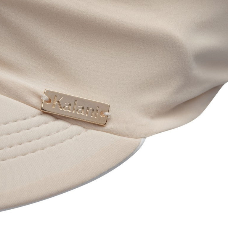 Close-up of a beige fabric with a brand label on a white background