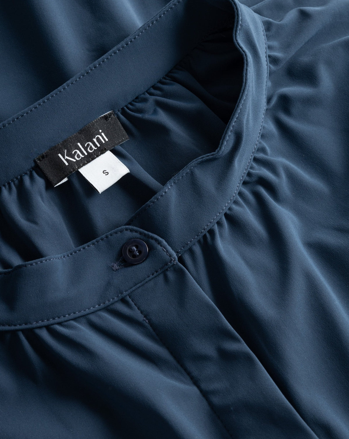 Close-up of the Milano blouse's soft, stretchy technical fabric