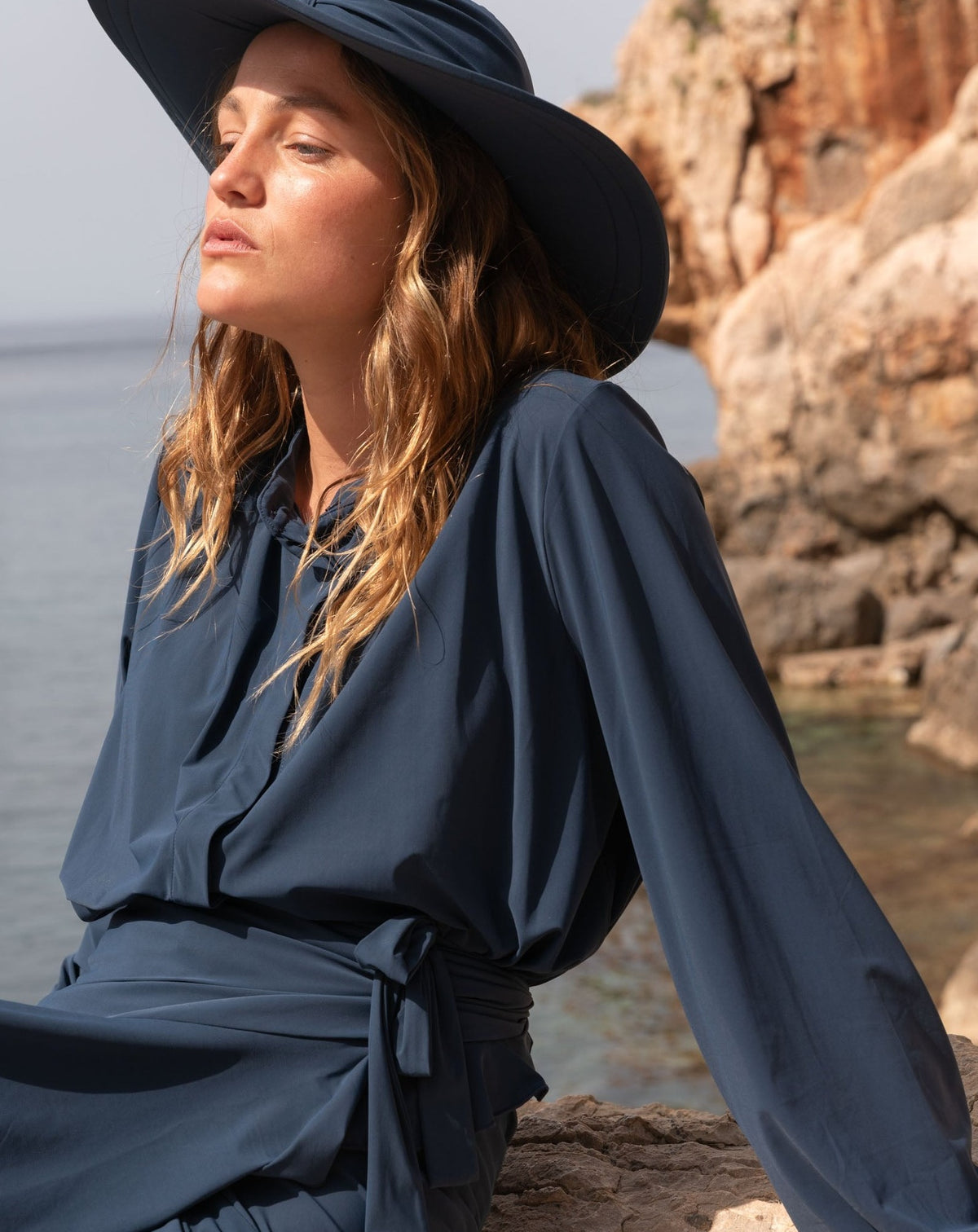 picures of women with modest long sleeve navy blouse and matching sun hat and skirt